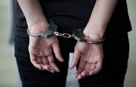 Criminal in handcuffs arrested for crimes